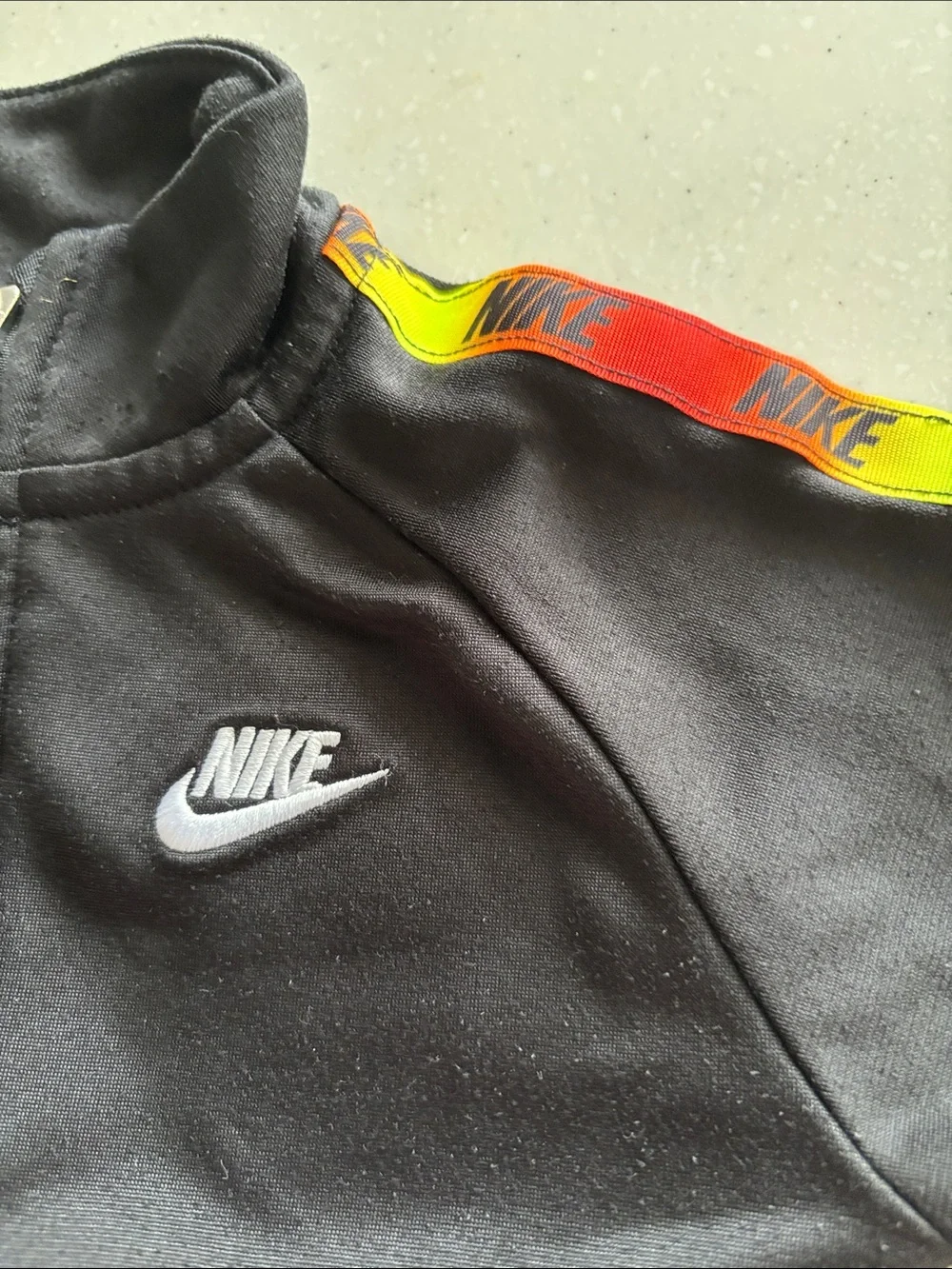 Nike Black Kids Track Set with Red and Yellow Stripe